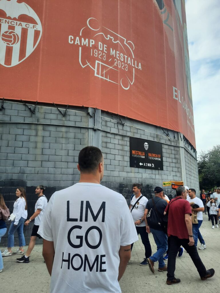 Juan stands in front of Mestalla wearing his Lim Go Home t-shirt. 